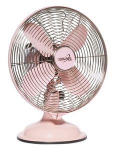 a pink fan sitting on top of a table