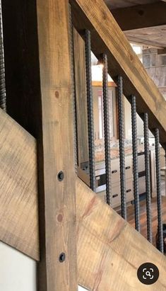 a wooden stair case with metal balconies