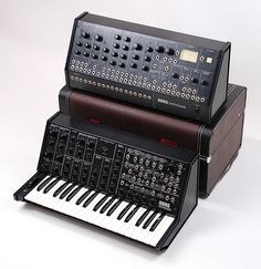 two electronic keyboards sitting side by side on top of each other in front of a white background