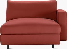 a red couch sitting on top of a white floor