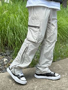 Editor's NoteCLACO's Nylon Side Zipper Cargo Pants are made out of nylon 100% fabric that has a subtle glow and light weight. With the side zippers extending up to up to the knees that makes the fit wider, you can style it in various ways. It has adjustable string on the waistband for comfortable wear. You can style it with various items for casual, relaxed, and trendy look during various seasons. - Adjustable waistband with string- Side zippers- Side cargo pockets- Adjustable silhouetteMeasurements (in.)M/L- Waist: 14.17 in / 14.96 in- Thigh: 12.60 in / 13.39 in- Rise: 12.60 in / 12.99 in- Hem: 8.27 in / 8.66 in- Length: 40.94 in / 41.73 inModel info: Height 5'11, Weight 169 lbs, Wearing size LComposition & Care- Nylon 100%- Refer to care labelDesigner- by CLACO Urban Cargo Pants With Zip Fly For Outdoor, Utility Parachute Pants With Zipper For Streetwear, Full Length Nylon Parachute Pants For Streetwear, Utility Parachute Pants With Zip Fly For Outdoor, Full Length Nylon Cargo Pants For Streetwear, Casual Nylon Pants With Zip Fly, Casual Bottoms With Zipper Closure For Outdoor Activities, Nylon Cargo Pants With Zip Fly For Outdoor, Outdoor Nylon Cargo Pants With Zip Fly