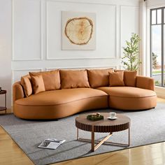 a living room with a large sectional couch and coffee table in front of a sliding glass door