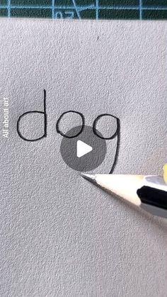 a pencil drawing the word dog on top of a piece of paper with an eraser