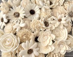 a bunch of white flowers sitting on top of a wooden table