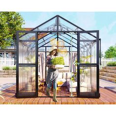 a woman standing in front of a green house