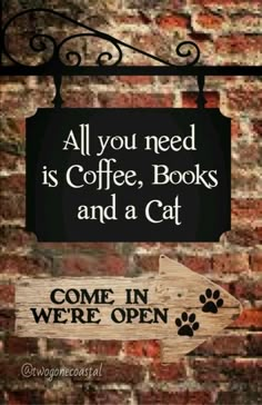 a sign that says all you need is coffee, books and a cat come in we're open