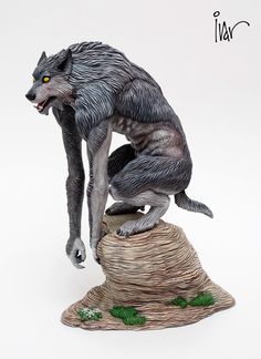 a statue of a wolf on top of a tree stump