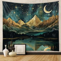 a wall hanging tapestry with mountains and stars in the night sky over a body of water