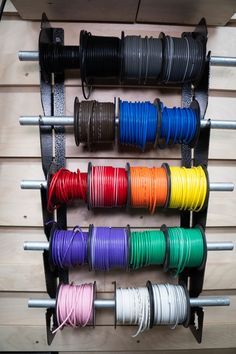 there are many different colored cords on the rack