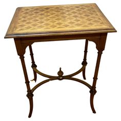 an old wooden table with a checkered design on the top and bottom shelf,