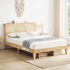 a bed sitting on top of a wooden floor next to a window