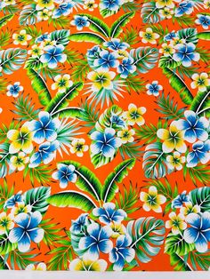 an orange background with blue and white flowers