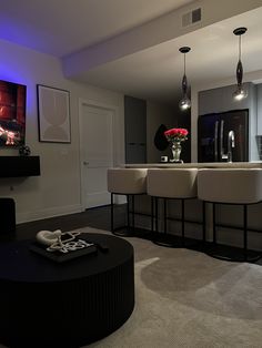 a living room filled with furniture and a flat screen tv mounted to the side of a wall