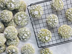 a cooling rack filled with cookies covered in powdered sugar