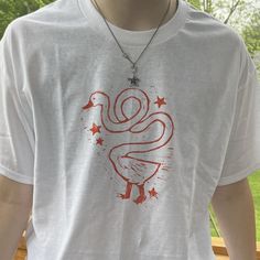 hand-stamped shirt for the goose lovers! there's a fun little star stamp detail on each sleeve :) 2X and 3X sizes are sometimes more difficult for me to get, so i appreciate your patience if your order takes a little longer than expected! shirts are printed on gildan short sleeve adult t-shirt, 100% cotton i use speedball screen-printing ink, which should hold up well in the wash, but if you want to make extra sure your shirt won't fade, i would recommend a gentle and cold wash cycle Screen Printed T Shirts, T Shirt Hand Painting Ideas, Linocut Print Shirt, Hand Painted Clothing T Shirts, Painted Tee Shirts, Fun Tshirt Designs, Stamp Shirts, T Shirt Painting Ideas Creative, Stamped Shirt