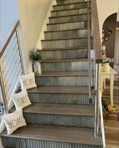 a set of stairs leading up to a home sweet home sign on the handrail