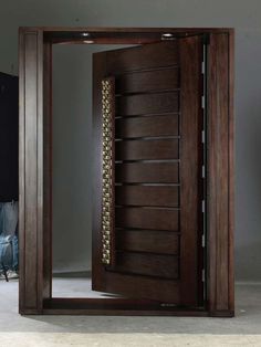 an open wooden door with decorative designs on the front and side panels in dark wood