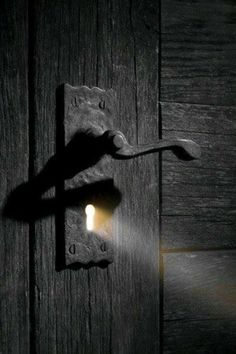 the light shines brightly on an old door handle