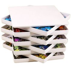 a stack of white boxes filled with lots of different items