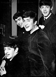 the beatles posing for a black and white photo