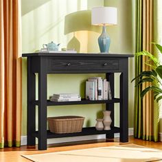 a black table with a shelf on it in front of a green wall and curtains