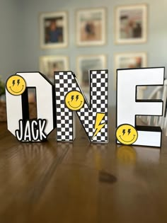 the word love spelled out in letters with smiley faces and checkered pattern on them