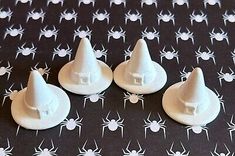 four white plastic hats with spider webs on black background, set of 6 pieces