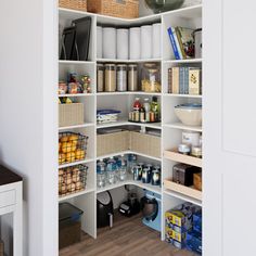 an organized pantry with white shelving and baskets