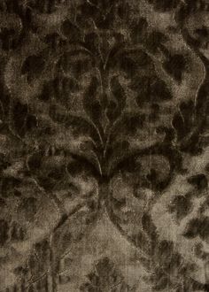 a black and white photo of an intricate design on fabric, with very detailed details