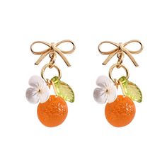 two oranges with leaves and flowers are hanging from gold ear wires on a white background