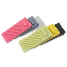 four combs are lined up in different colors on a white background, one is black, the other is yellow