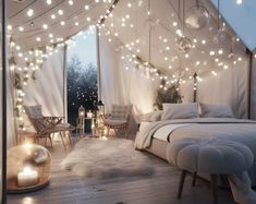 a bed sitting under a tent covered in lights