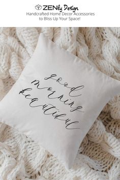 a white pillow with black lettering on it