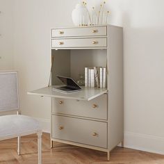 a white desk with a laptop on top of it