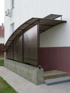 an awning on the side of a building with steps leading up to it's entrance