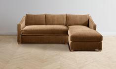 a brown couch sitting on top of a wooden floor