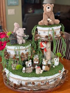 there are many stuffed animals on the top of this tree stumps and plants in front of them