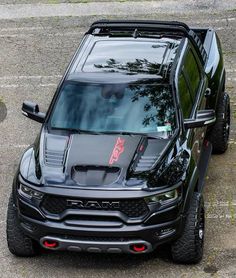 a black truck parked on top of a parking lot