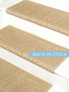 two beige carpeted stairs with the words back in stock written on one side and bottom