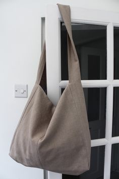 A really lovely large bag made in pure linen called Cambridge. It can be comfortably worn across the body for every day use. This lovely Natural one has been made of different size panels of fabric, creating unique seam details......each bag very different from the next! Fully lined in cotton shirt fabrics, with two internal pockets. The shirts used to line our bags are from quality shirt makers of Jermyn Street, London. Most of our linens are hand-dyed, meaning that there are slight variations Tela, Handpainted Bags, Small Business Packaging Ideas, Baby Changing Bags, Changing Bag, Shirt Maker, Linen Bag, Handmade Boho, Large Bag