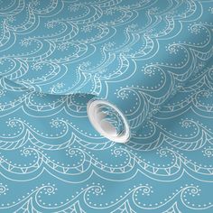 a blue wallpaper with white swirls on it