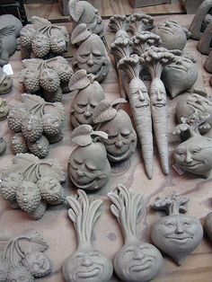 many clay faces and heads are on display