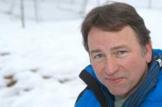 a man wearing a blue jacket in the snow