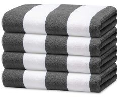 four towels stacked on top of each other in grey and white stripes, with one folded up