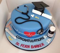 a cake with a stethoscope, mortar, and graduation cap on it