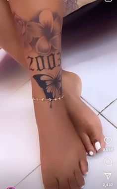 a woman's foot with a butterfly tattoo on her left arm and the word 2012 written in black ink