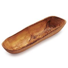 a wooden boat shaped dish on a white background