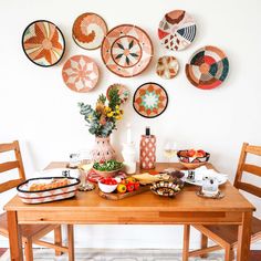 a wooden table topped with plates and bowls