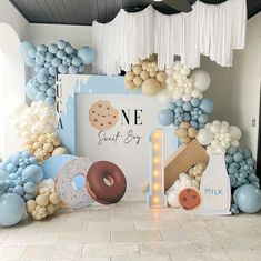 a table topped with balloons and doughnuts