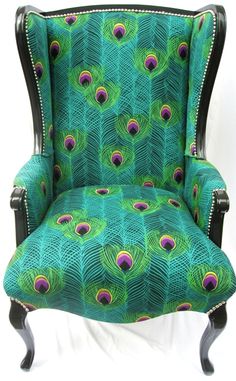 a green chair with peacock feathers on it